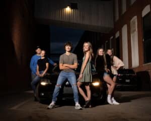 car in the alley with a high school senior, partner and family