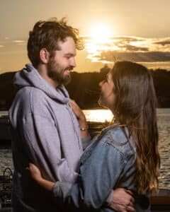 couple embracing at sunset after becoming engaged