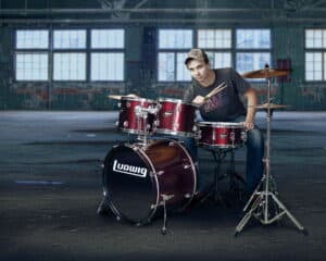 picture of a High School Senior with a drum set in a warehouse